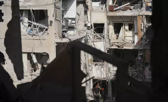 Israeli soldiers search for survivors amid the rubble of residential buildings destroyed by an Iranian missile strike in Bat Yam, central Israel, on Sunday, June 15, 2025. (AP Photo/Ariel Schalit)