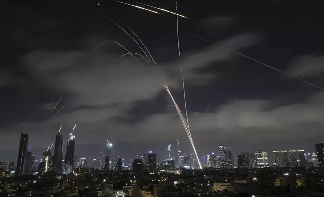 Israeli Iron Dome air defense system fires to intercept missiles over Tel Aviv, Israel, early Sunday, June 15, 2025. (AP Photo/Leo Correa)