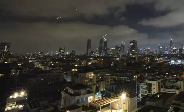 Traces are seen from Tel Aviv during a missile attack, Israel, on Saturday, June 14, 2025. (AP Photo/Ohad Zwigenberg)