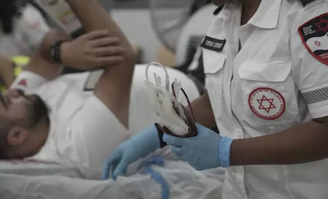 Medics with Israel's Magen David Adom emergency service take part in a blood drive to prepare for mass casualties in the event of strikes by Iran, in Jerusalem, Saturday, June 14, 2025. (AP Photo/Maya Alleruzzo)