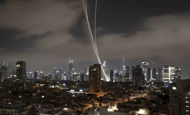 Israeli Iron Dome air defense system fires to intercept missiles over Tel Aviv, Israel, early Sunday June 15, 2025. (AP Photo/Ohad Zwigenberg)