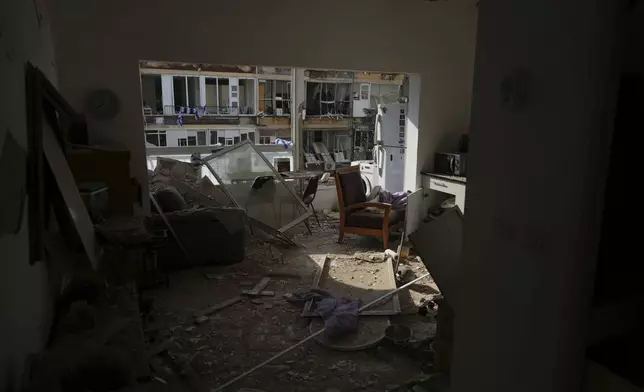 A heavily damaged apartment in a residential building building that was hit by a missile fired from Iran, near Tel Aviv, Israel, Sunday, June 15, 2025.(AP Photo/Ariel Schalit)