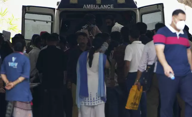 An ambulance transport the body of the victims of Thursday's Air India plane crash at a hospital in Ahmedabad, India, Sunday, June 15, 2025. (AP Photo/Ajit Solanki)