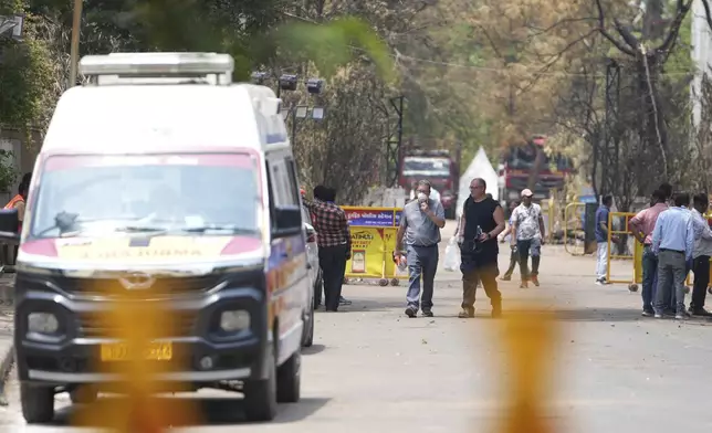 Investigators come out after visiting Thursday's Air India plane crash site in Ahmedabad, India, Sunday, June 15, 2025. (AP Photo/Ajit Solanki)