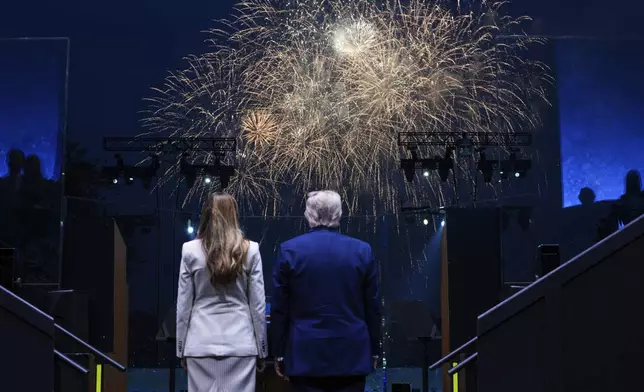 President Donald Trump and first lady Melania Trump watch fireworks following a parade to honor the Army's 250th anniversary, coinciding with Trump's 79th birthday, Saturday, June 14, 2025, in Washington. (Doug Mills/The New York Times via AP, Pool)