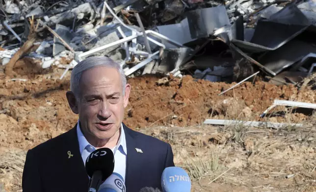 Israel's Prime Minister Benjamin Netanyahu gives a statement during a visit to the site of the Weizmann Institute of Science, which was hit by missiles fired from Iran, in the central city of Rehovot on Friday, June 20, 2025. (Jack Guez/Pool Photo via AP)