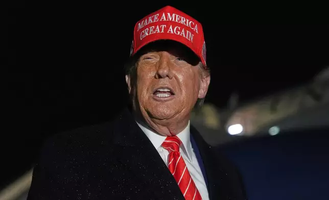President Donald Trump speaks to reporters in the rain after arriving on Air Force One at Joint Base Andrews, Md., Friday, May 30, 2025. (AP Photo/Julia Demaree Nikhinson)