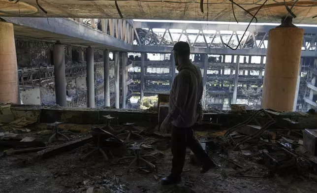 A man walks in the damaged headquarters of Islamic Republic of Iran Broadcasting, Iranian state television, in Tehran, Iran, Thursday, June 19, 2025. (AP Photo/Vahid Salemi)