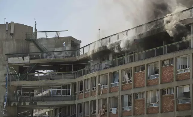 Smokes raises from a building of the Soroka hospital complex after it was hit by a missile fired from Iran in Be'er Sheva, Israel, Thursday, June 19, 2025. (AP Photo/Leo Correa)