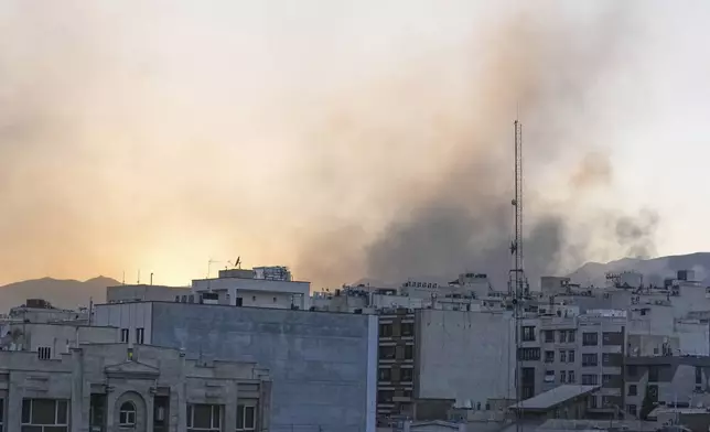 Smoke rises up after Israel's attack, in Tehran, Iran, Wednesday, June 18, 2025. (AP Photo/Vahid Salemi)