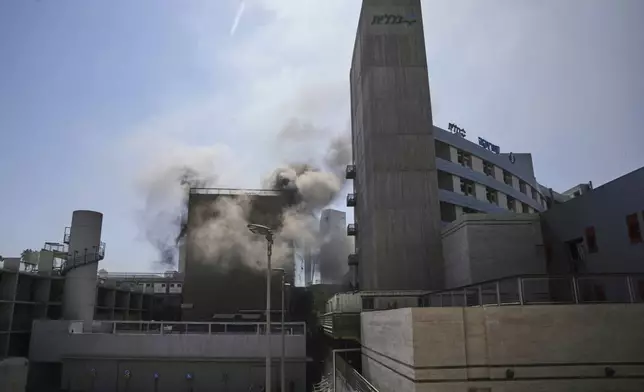 Smokes raises from a building of the Soroka hospital complex after it was hit by a missile fired from Iran in Be'er Sheva, Israel, Thursday, June 19, 2025. (AP Photo/Leo Correa)