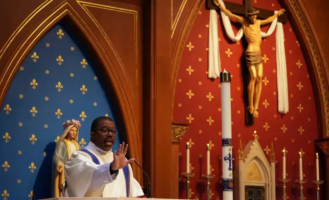 The Rev. Ricky Malebranche speaks to congregants during a Mass at St. Louis Catholic Church in Alexandria, Va., on Saturday, May 24, 2025. (AP Photo/Luis Andres Henao)
