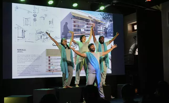 A group of theater artists perform to highlight the benefits of Neralu, an innovative portable heat shelter, at the Sweat and Concrete 2025 event in Bengaluru, India, Thursday, May 29, 2025. (AP Photo/Aijaz Rahi)