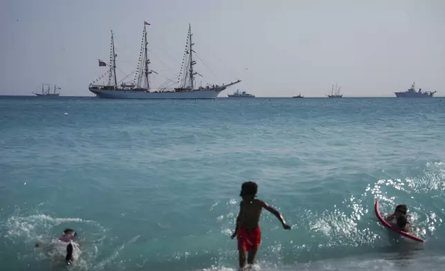 People swim as vessels sail during the "Ocean Wonders" event in honor of World Oceans Day ahead of the U.N. Ocean Conference on Sunday, June 8, 2025, in Nice, France. (AP Photo/Annika Hammerschlag)