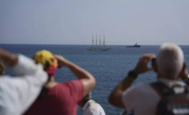People take photos of vessels during the "Ocean Wonders" event in honor of World Oceans Day ahead of the U.N. Ocean Conference on Sunday, June 8, 2025, in Nice, France. (AP Photo/Annika Hammerschlag)
