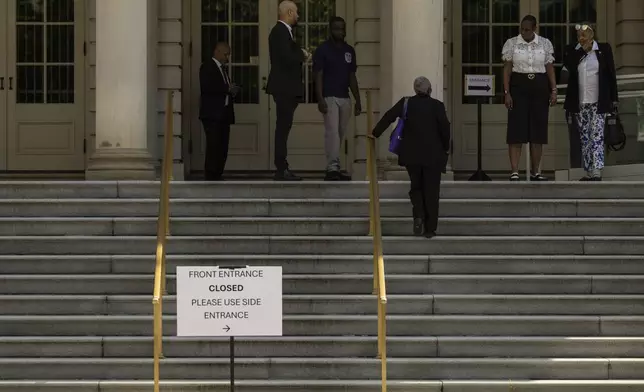 People stand on the stairs to see the casket of former Rep. Charles Rangel, D-N.Y., in the rotunda of New York's City Hall, Thursday, June 12, 2025. (AP Photo/Yuki Iwamura)