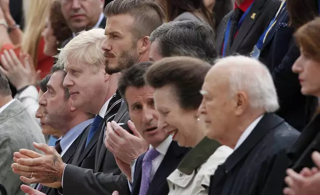 FILE - Greek President Karolos Papoulias, right, Princess Anne of Britain, second right, Former England football captain David Beckham, fifth right, and London Mayor Boris Johnson, sixth right, attend an Olympic Flame handover ceremony at the Panathenean stadium in Athens, on Thursday, May 17, 2012. (AP Photo/Petros Giannakouris, File)