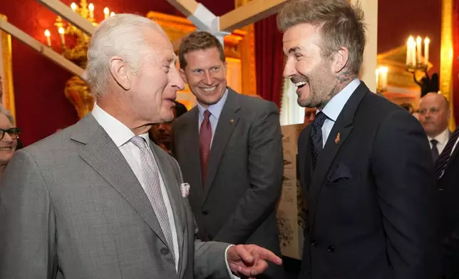 FILE - Britain's King Charles III, left speaks to former footballer David Beckham as they attend the inaugural King's Foundation charity awards at St James's Palace in London, Tuesday, June 11, 2024. (AP Photo/Kirsty Wigglesworth, Pool, File)