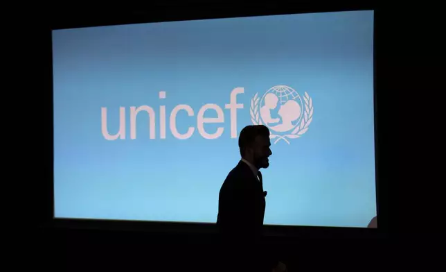 FILE - Former English national soccer team captain David Beckham is silhouetted as he arrives to speak at a press conference to mark his 10 years as a goodwill ambassador for UNICEF and to launch '7', a new fund for children in danger across the globe, in London, Monday, Feb. 9, 2015. (AP Photo/Matt Dunham, File)