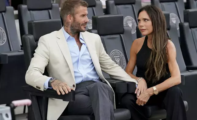 FILE - Inter Miami co-owner David Beckham, left, sits with his wife Victoria before a Leagues Cup soccer match between Inter Miami and Atlanta United, Tuesday, July 25, 2023, in Fort Lauderdale, Fla. (AP Photo/Lynne Sladky, File)