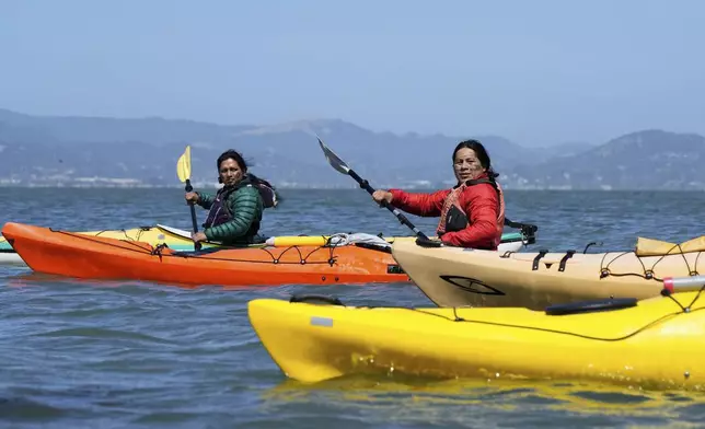 From left, Juan Bay, president of the Waorani people of Ecuador, and Nadino Calapucha, a spokesperson for the Kichwa Pakkiru people, kayak in the San Francisco Bay, Thursday, June 19, 2025, in Richmond, Calif. (AP Photo/Godofredo A. Vásquez)