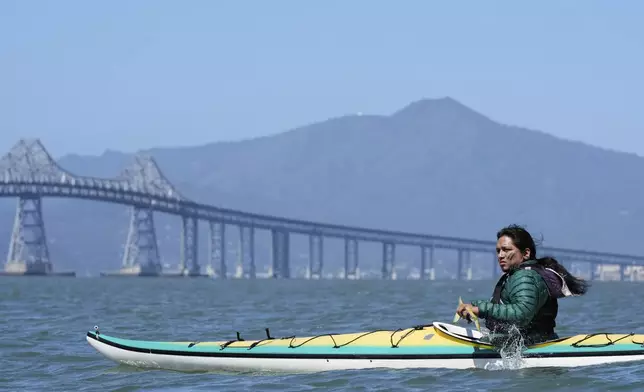 Juan Bay, president of the Waorani people of Ecuador, kayaks in the San Francisco Bay toward the Chevron Long Wharf, Thursday, June 19, 2025, in Richmond, Calif. (AP Photo/Godofredo A. Vásquez)