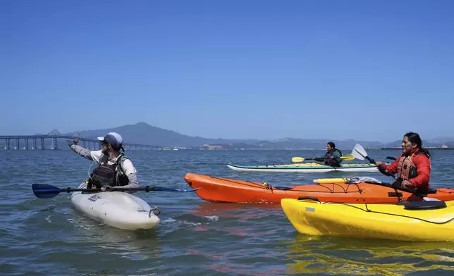 Casey Stewart, left, directs a delegation of Indigenous leaders from Ecuador on a path to kayak and see the Chevron Long Wharf, Thursday, June 19, 2025, in Richmond, Calif. (AP Photo/Godofredo A. Vásquez)