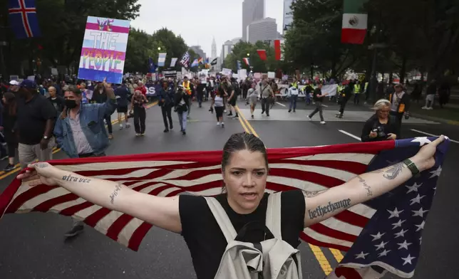 Demonstrators march down Benjamin Franklin Parkway during the "No Kings" protest, Saturday, June 14, 2025, in Philadelphia. (AP Photo/Yuki Iwamura)