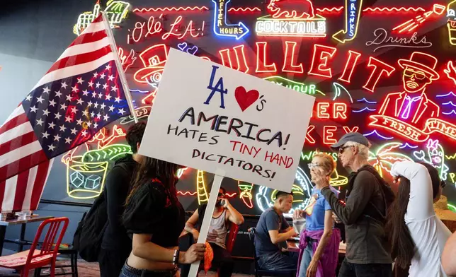 Demonstrators walks through Grand Central Market during a protest Saturday, June 14, 2025, in Los Angeles. (AP Photo/Noah Berger)