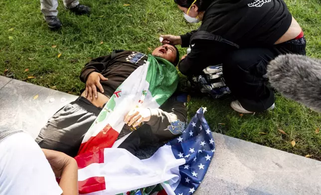 A man receives treatment after being tear-gassed during a protest Saturday, June 14, 2025, in Los Angeles. (AP Photo/Noah Berger)