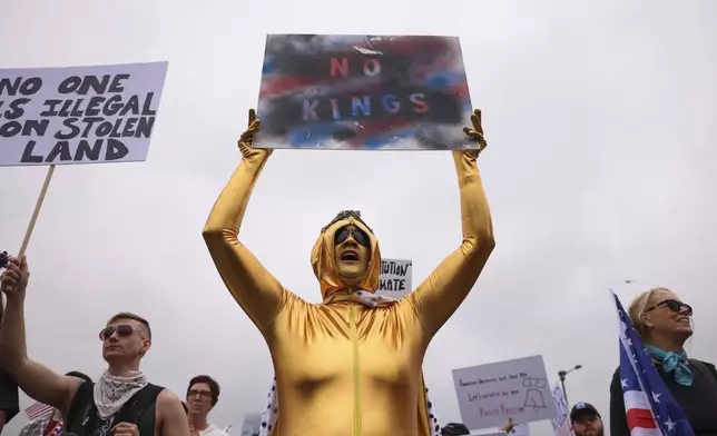 A woman, who identified herself only as Stephanie, center, demonstrates during the "No Kings" protest, Saturday, June 14, 2025, in Philadelphia. (AP Photo/Yuki Iwamura)