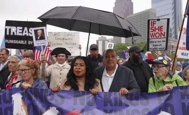 Martin Luther King III, center right, and his wife Arndrea Waters King, center left, march in the "No Kings" protest, Saturday, June 14, 2025, in Philadelphia. (AP Photo/Yuki Iwamura)