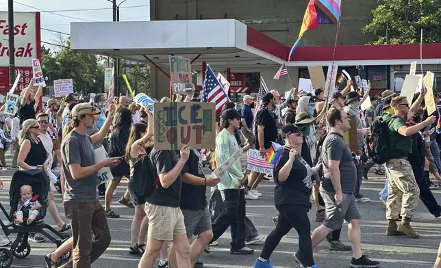 Demonstrators carry signs and chant while marching during a “No Kings” protest, Saturday, June 14, 2025, in Salt Lake City. (AP Photo/Amanda Barrett)
