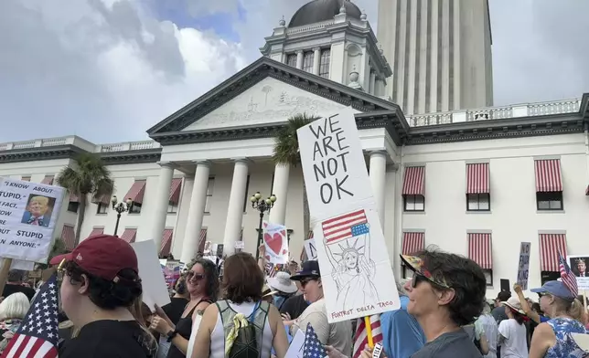 People gather on the grounds of Florida’s old capitol in Tallahassee, Fla., for “No Kings” protest on Saturday, June 14, 2025. (AP Photo/Kate Payne)