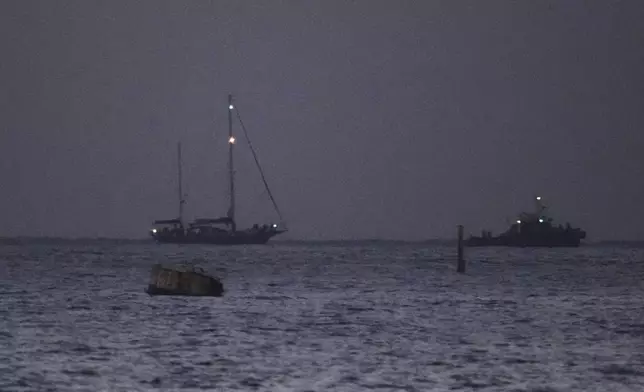 The Gaza-bound aid boat, Madleen, left, under escort of Israeli naval forces making its way toward Ashdod Port in southern Israel after being seized by Israeli forces, Monday, June 9, 2025. (AP Photo/Leo Correa)
