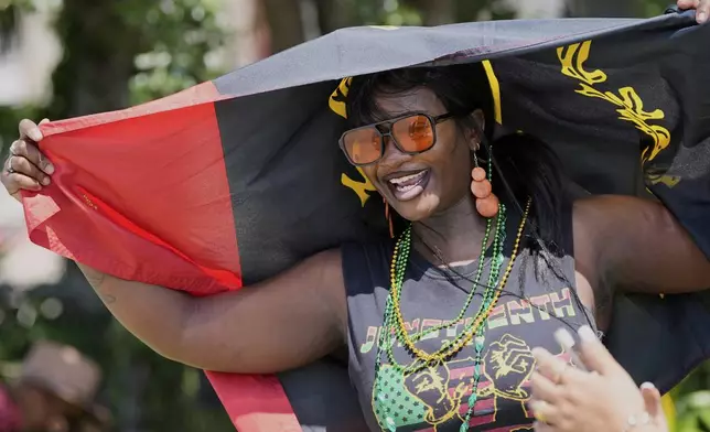 Monet Jacobs sings during a Juneteenth parade Thursday, June 19, 2025, in Galveston, Texas. (AP Photo/David J. Phillip)