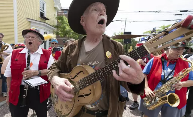 T.J. Wheeler sings along with the Leftist Marching Band during a Juneteenth celebration at the African Burying Ground Memorial Park Thursday, June 19, 2025, in Portsmouth, N.H. (AP Photo/Michael Dwyer)