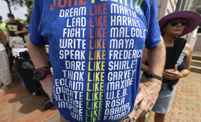 Paul Wendell wears a Juneteenth themed t-shirt during a Juneteenth celebration at the African Burying Ground Memorial Park Thursday, June 19, 2025, in Portsmouth, N.H. (AP Photo/Michael Dwyer)