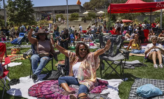 Areda Boyd, left, and DeAnna Baldridge, center, dance at the Oakland Museum to celebrate Juneteenth in Oakland, Calif., on Thursday, June 19, 2025.(Gabrielle Lurie/San Francisco Chronicle via AP)