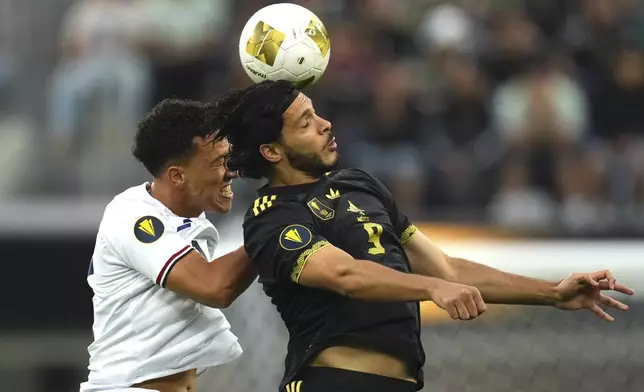 Dominican Republic midfielder Jean López (14) and Mexico forward Raúl Jiménez (9) try to head the ball during the first half of a CONCACAF Gold Cup soccer match Saturday, June 14, 2025, in Inglewood, Calif. (AP Photo/Mark J. Terrill)