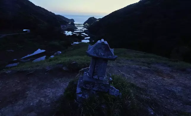 A Shinto shrine stands on a hilltop which was previously a cemetery for Christians in Ikitsuki Island in Hirado, southern Japan, Monday, April 28, 2025. (AP Photo/Hiro Komae)