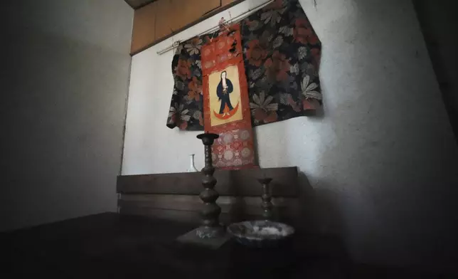 A scroll of the Virgin Mary and Jesus once secretly worshipped hangs at a home in Ikitsuki Island in Hirado, southern Japan, Sunday, April 27, 2025. (AP Photo/Eugene Hoshiko)