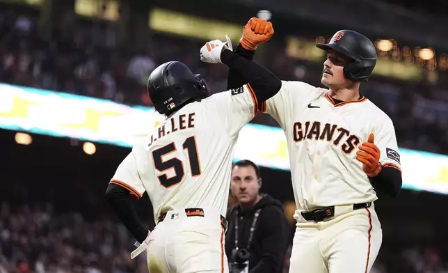 San Francisco Giants' Matt Chapman, right, celebrate with Jung Hoo Lee after hitting a two-run home run during the sixth inning of a baseball game against the San Diego Padres, Wednesday, June 4, 2025, in San Francisco. (AP Photo/Godofredo A. Vásquez)