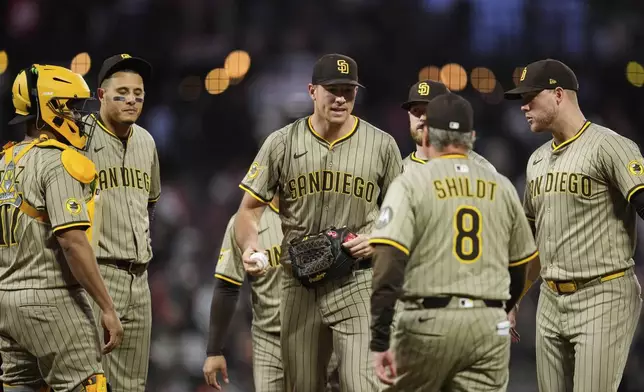 San Diego Padres pitcher Nick Pivetta, center, hands the ball over to manager Mike Shildt as he exits during the seventh inning of a baseball game against the San Francisco Giants, Wednesday, June 4, 2025, in San Francisco. (AP Photo/Godofredo A. Vásquez)