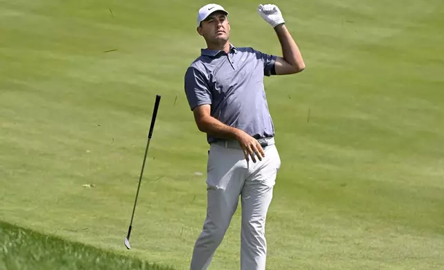 Scottie Scheffler drops his club after hitting his second shot from the rough on the first hole during the second round of the Travelers Championship golf tournament at TPC River Highlands, Friday, June 20, 2025, in Cromwell, Conn. (AP Photo/Jessica Hill)