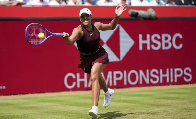 Madison Keys of the U.S. returns the ball to Germany's Tatjana Maria during their semifinal match on day six of the HSBC Championships at The Queen's Club, London, Saturday June 14, 2025. (John Walton/PA via AP)