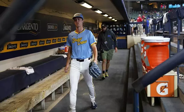 Milwaukee Brewers pitcher Jacob Misiorowski (33) walks through the dugout before warming up for his major league debut in a baseball game against the St. Louis Cardinals, Thursday, June 12, 2025, in Milwaukee. (AP Photo/Kayla Wolf)