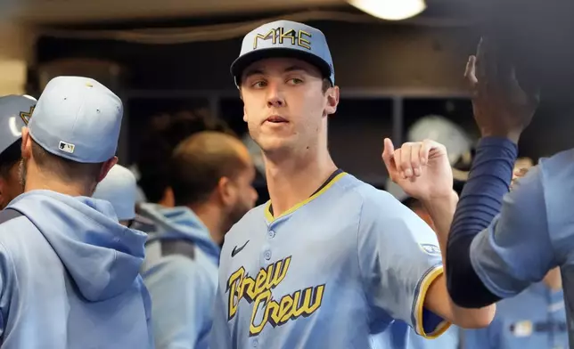 Milwaukee Brewers pitcher Jacob Misiorowski high-fives teammates after exiting a baseball game against the St. Louis Cardinals due to an ankle injury during the sixth inning of his major league debut Thursday, June 12, 2025, in Milwaukee. (AP Photo/Kayla Wolf)