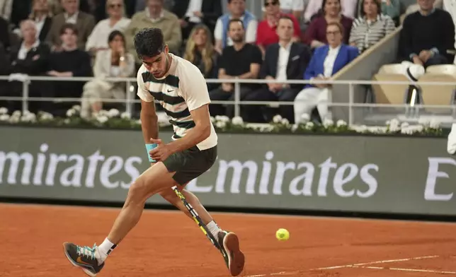 Spain's Carlos Alcaraz plays a shot against Italy's Lorenzo Musetti during their semifinal match of the French Tennis Open at the Roland-Garros stadium in Paris, Friday, June 6, 2025. (AP Photo/Thibault Camus)