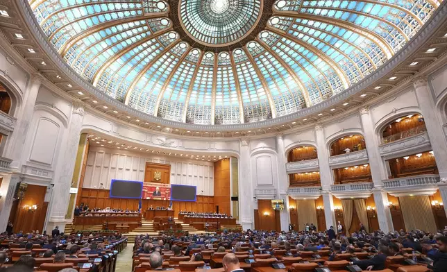 Romanian Prime Minister designate Ilie Bolojan addresses a joint parliament session ahead of a vote of confidence for the new government team in Bucharest, Romania, Monday, June 23, 2025. (AP Photo/Andreea Alexandru)
